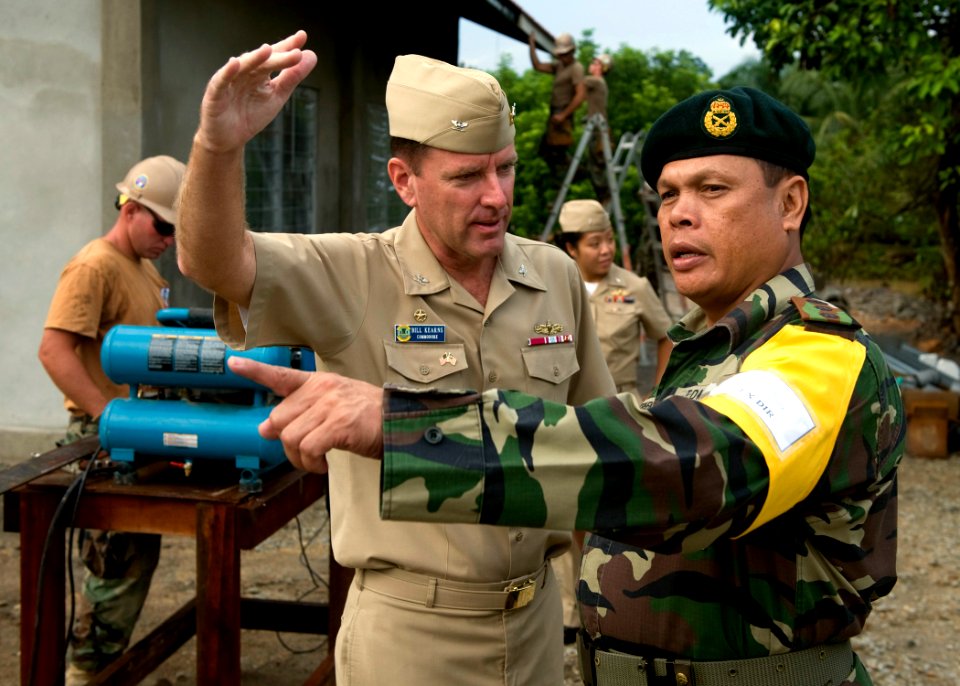 US Navy 090624-N-1722M-110 U.S. Navy Commodore Bill Kearns, commander, Task Group 73.5, left, and Malaysian Army Col. Stephen Mundaw discuss an engineering civil action project job site during Cooperation Afloat Readiness and T