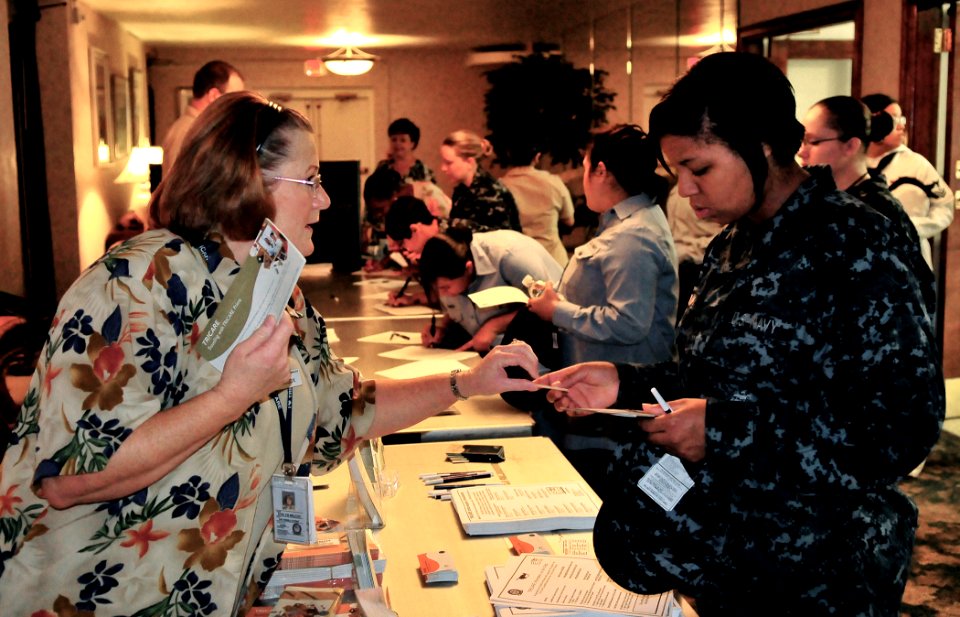 US Navy 090625-N-8933S-001 Tricare representative Janise Wilcox hands out information packets on Tricare to Electrician's Mate Fireman Samantha Franklin during the Naval Station Norfolk pregnancy seminar