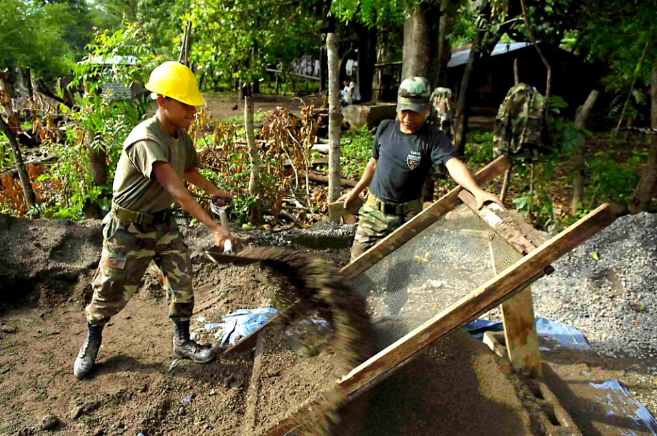 US Navy 090626-F-7923S-124 Salvadoran Army engineers grate gravel for Seabees assigned to Construction Battalion Maintenance Unit (CBMU) 202 to mix into cement for the areas around Caserio Havillal School
