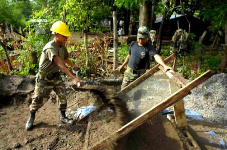 US Navy 090626-F-7923S-124 Salvadoran Army engineers grate gravel for Seabees assigned to Construction Battalion Maintenance Unit (CBMU) 202 to mix into cement for the areas around Caserio Havillal School