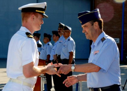 US Navy 090626-N-XXXXG-004 Lt. Abram Stroot, left, receives the Spanish Air Force Safety of Flight trophy from Chief of Staff of the Spanish Armed Forces Gen. Jose Julio Rodriguez Fernandez