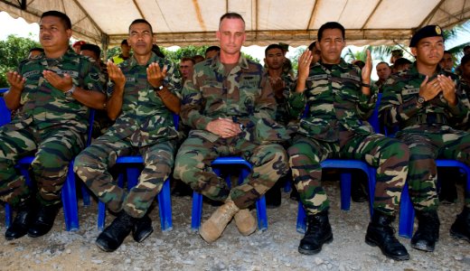 US Navy 090630-N-1722M-172 Chief Builder Eric Johnson, assigned to Naval Mobile Construction Battalion (NMCB) 40, center, joins soldiers from the Malaysian Army 91st Royal Construction Regiment in prayer photo