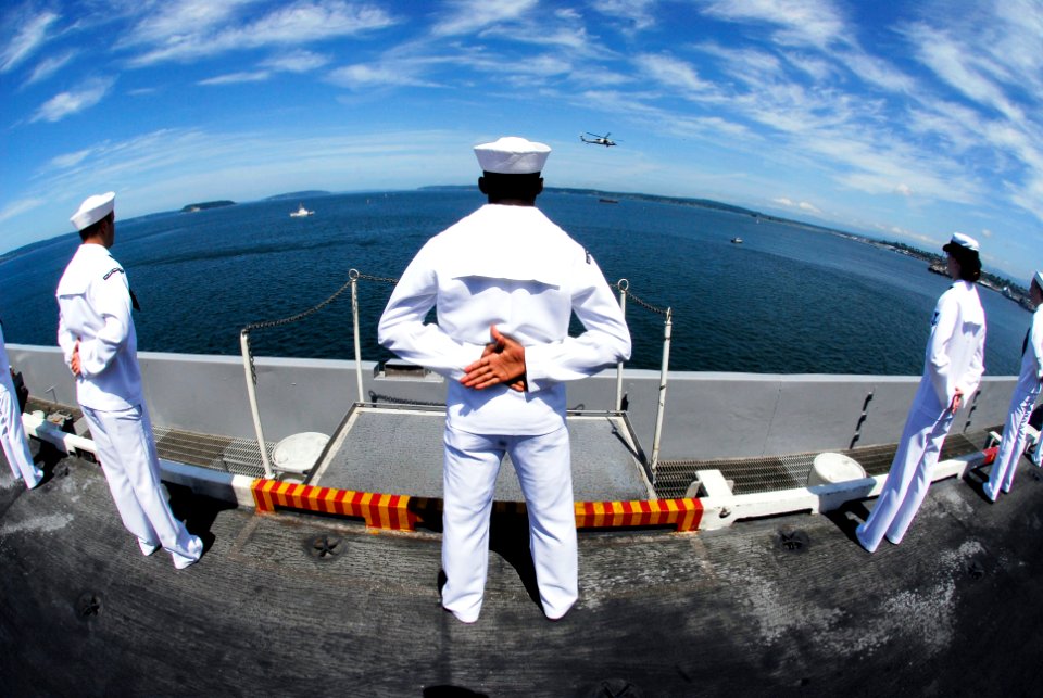 US Navy 090629-N-7780S-051 Sailors man the rails as the aircraft carrier USS John C. Stennis (CVN 74) pulls into Everett, Wash. for a scheduled port visit to embark family and friends for a Tiger Cruise