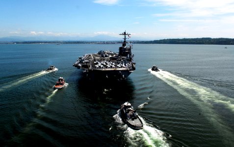 US Navy 090629-N-9928E-366 Tug boats escort the aircraft carrier USS John C. Stennis (CVN 74) as the ship pulls into Everett, Wash., for a scheduled port visit as the ship prepares to pick up family and friends for a Tiger Crui
