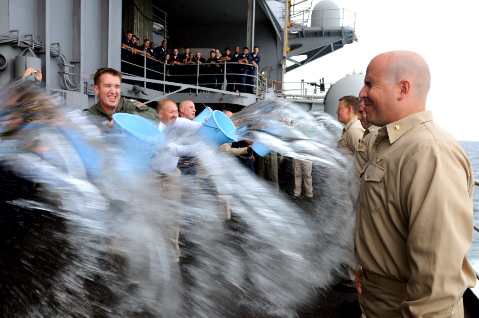 US Navy 090701-N-4995K-052 Newly promoted officers get soaked during a