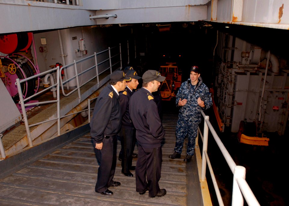 US Navy 090630-N-0924R-002 Lt. j.g. Scott Cheney-Peters, weapons officer aboard the amphibious dock landing ship USS Oak Hill (LSD 51), conducts a tour of the well deck for Navy of the Argentine Republic officers