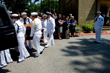 US Navy 090627-N-4154B-103 The family of Command Master Chief Jeffrey Garber, command master chief of Carrier Air Wing (CVW) 7, looks on as the Garber's casket is loaded into a hearse at Oceana Naval Air Station