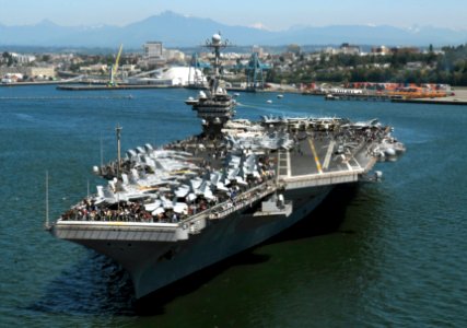 US Navy 090701-N-6538W-040 Sailors, and Tigers Cruise participants gather on the flight deck of the aircraft carrier USS John C. Stennis (CVN 74) as the ship gets underway from Everett, Wash
