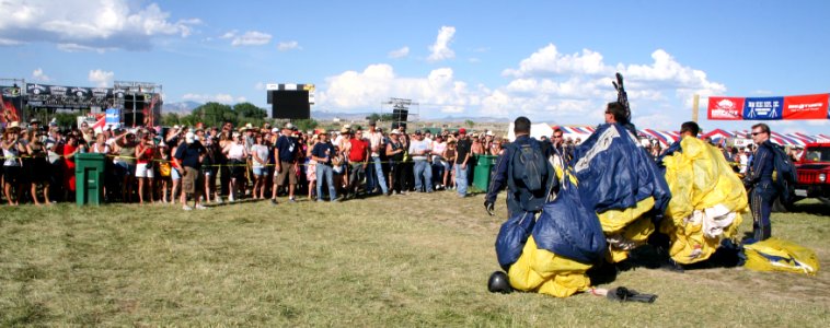 US Navy 090628-N-5366K-039 Chief Special Warfare Operator (SEAL) William Davis, assigned to the U.S. Navy Parachute Team, the Leap Frogs, waves to spectators after a demonstration jump during Military Appreciation Day photo