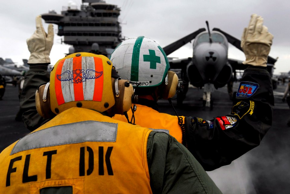 US Navy 090628-N-7780S-039 Capt. Gordon Smith, right, Air Boss of the Nimitz-class aircraft carrier USS John C. Stennis (CVN 74), directs an EA-6B Prowler from the