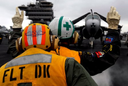 US Navy 090628-N-7780S-039 Capt. Gordon Smith, right, Air Boss of the Nimitz-class aircraft carrier USS John C. Stennis (CVN 74), directs an EA-6B Prowler from the