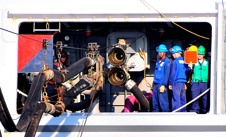 US Navy 090702-N-4774B-048 Sailors aboard amphibious transport dock ship USS New Orleans (LPD 18) stand by while receiving a fuel line from fleet replenishment oiler USNS Tippecanoe (T-AO 199) during an underway replenishment
