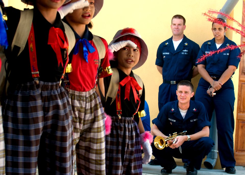 US Navy 090630-N-1722M-219 Musician 1st Class Danny McGowan, Musician 1st Class Luslaida Barbosa and Musician 2nd Class Collin Reichow, all assigned to the U.S. 7th Fleet Band, look on as students from Seberang Tayor Primary Sc