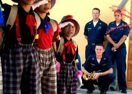 US Navy 090630-N-1722M-219 Musician 1st Class Danny McGowan, Musician 1st Class Luslaida Barbosa and Musician 2nd Class Collin Reichow, all assigned to the U.S. 7th Fleet Band, look on as students from Seberang Tayor Primary Sc