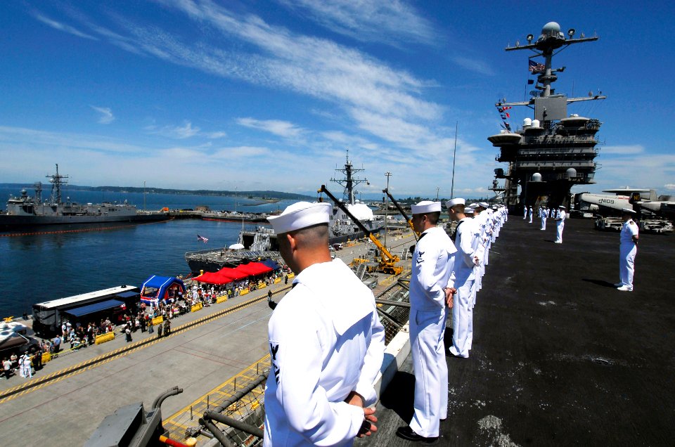 US Navy 090629-N-7780S-141 ailors man the rails as the aircraft carrier USS John C. Stennis (CVN 74) pulls into Everett, Wash. for a scheduled port visit to embark family and friends for a Tiger Cruise