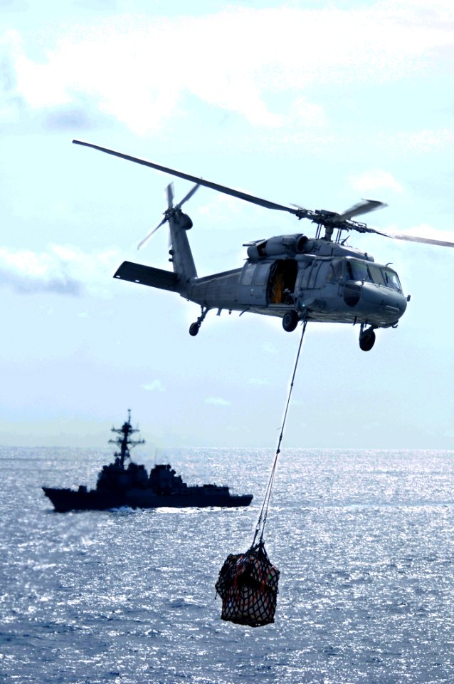 US Navy 090630-N-4995K-108 An MH-60S Sea Hawk helicopter assigned to the Blackjacks of Helicopter Sea Combat Squadron (HSC) 21 carries a cargo pendant