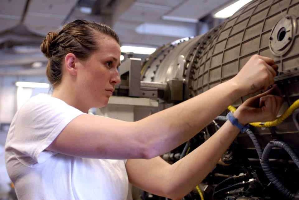 US Navy 090703-N-9132C-146 Aviation Machinist's Mate Airman Seana Sprayberry unscrews bolts to remove the top half of the combustor of a F404 engine