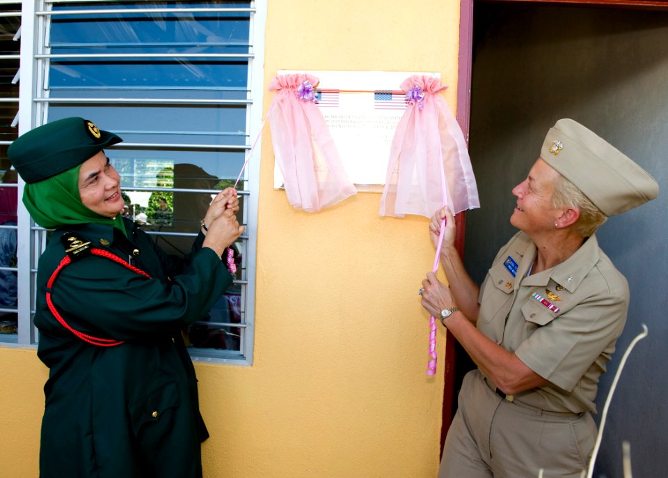 US Navy 090630-N-1722M-146 Roeaidah Binti Mt Jusoh, left, a Kuantan District education official and Rear Adm. Nora Tyson, Commander, Logistics Group Western Pacific, officially open a new multi-use building at Seberang Tayor Pr