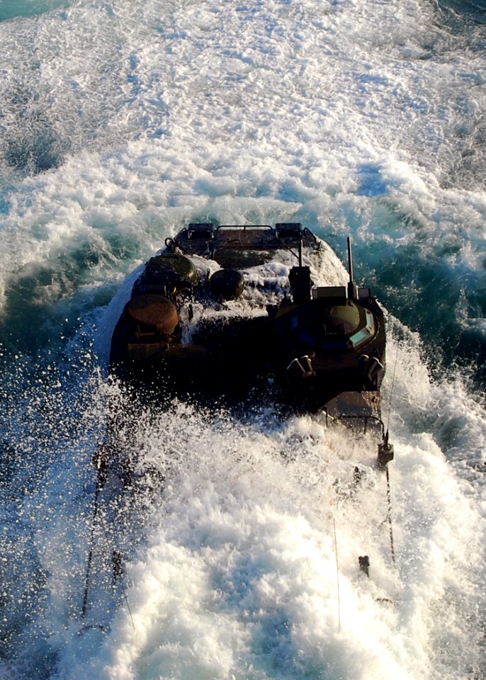 US Navy 090701-N-5207L-070 An amphibious assault vehicle transporting U.S. Marines and soldiers from the Malaysian Army 9th Royal Malay Regiment emerges from the water after launching from the well deck of the dock landing ship