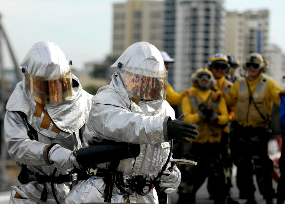 US Navy 090630-N-9520G-021 Sailors assigned to the air department crash and salvage team of the amphibious assault ship USS Essex (LHD 2) fight a simulated class bravo fire on the flight deck of the ship