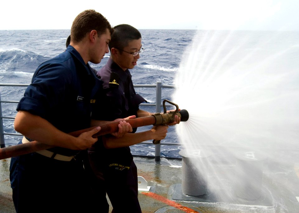 US Navy 090701-N-1251W-002 Midshipman 1st Class Tim McNerney, a student at the University of Colorado, relieves Japan Maritime Self-Defense Force Midshipman Kohei Ishida as the nozzleman