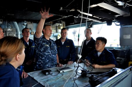 US Navy 090701-N-4124C-001 Lt. j.g. Trey J. Dittberner, navigator of the guided-missile cruiser USS Normandy (CG 60), explains the voyage management system to midshipmen