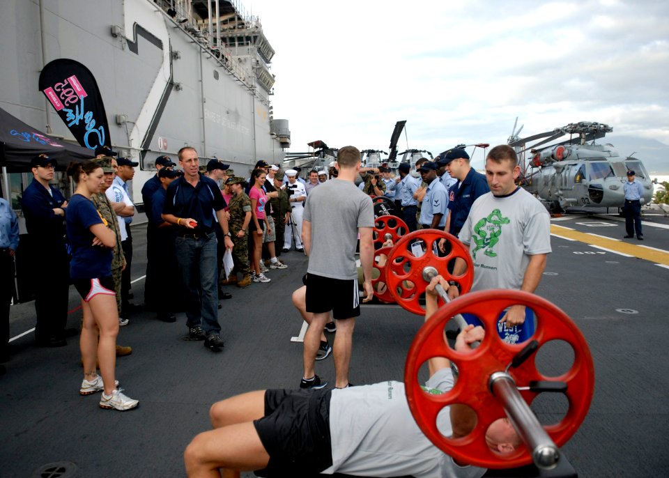 US Navy 090701-N-9520G-008 ailors aboard the amphibious assault ship USS Essex (LHD 2) prepare to participate in a timed weight lifting competition during a live broadcast of the