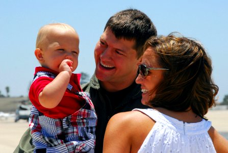 US Navy 090705-N-5617R-122 Lt. Matt Martin greets his wife and son during a homecoming celebration for the Raptors of Helicopter Maritime Strike Squadron (HSM) 71 at Naval Air Station North Island