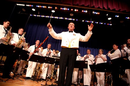 US Navy 090702-N-3271W-092 Lt. Carl Gerhard, director of the U.S. Navy Band Northeast leads the audience in singing the national anthem prior to a concert at Somerville High School photo