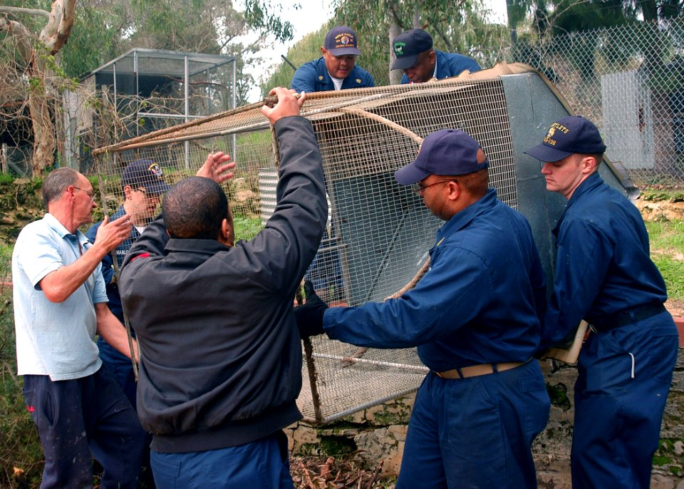 US Navy 090704-N-2757S-096 Sailors from the aircraft carrier USS George Washington (CVN 73) and Carrier Air Wing (CVW) 5 move a bird cage to a new location at the Native Animal Rehabilitation Centre during a community service p