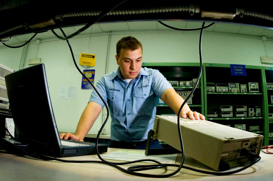 US Navy 090701-N-5821P-053 Aviation Electronics Technician Airman Alexander Vaizburd calibrates a digital multimeter in preparation for its distribution
