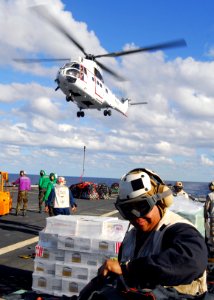 US Navy 090706-N-5538K-328 A Marine assigned to the 31st Marine Expeditionary Unit (31st MEU) works on the flight deck of the amphibious transport dock ship USS Denver (LPD 9) to bring aboard stores during simultaneous underway