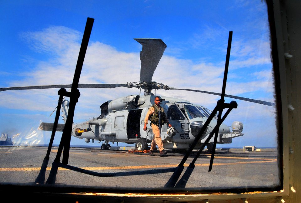 US Navy 090702-N-4774B-089 Lt. Cmdr. Michael Powell, assigned to the Wolfpack of Helicopter Anti-Submarine Squadron Light (HSL) 45, Detachment 4, prepares for flight operations aboard the guided-missile cruiser USS Lake Champla