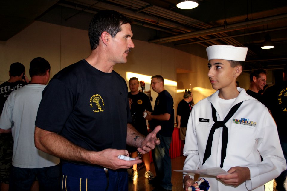 US Navy 090702-N-5366K-333 Chief Special Warfare Operator (SEAL) William Davis, assigned to the U.S. Navy Parachute Team the Leap Frogs, talks to a U.S. Navy Sea Cadet Corps cadet from the Seal Beach Battalion