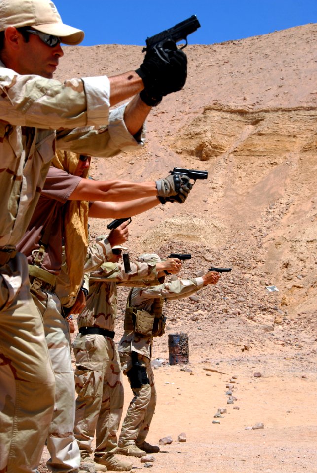 US Navy 090705-N-5710P-035 U.S. Navy explosive ordnance disposal technicians demonstrate a course of basic combat marksmanship with the M9 service pistol during operation Infinite Response 09