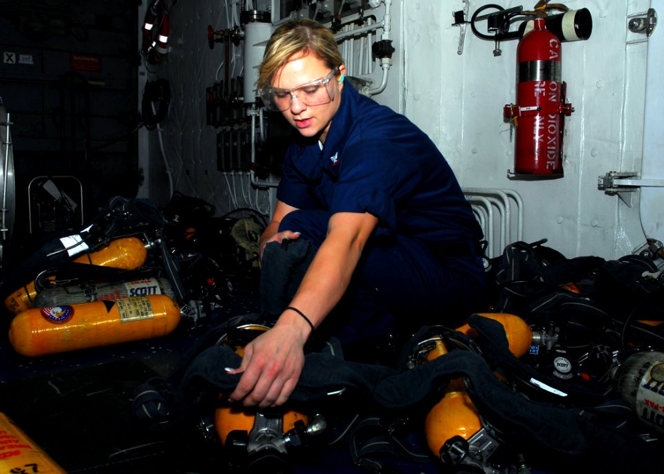 US Navy 090706-N-0515W-010 Damage Controlman 3rd Class Valerie Malloy refills self-contained breathing apparatus tanks aboard the amphibious assault ship USS Bonhomme Richard (LHD 6)