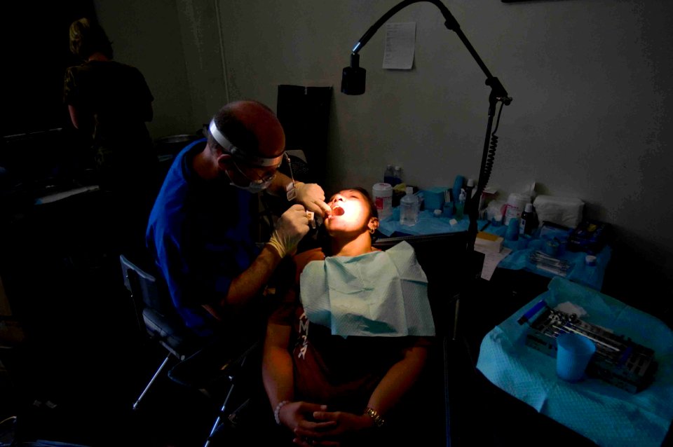 US Navy 090707-N-9689V-006 Mark Coussens, volunteer dentist of University of California, San Diegos Pre-dental Society, provides dental treatment to locals at a Pacific Partnership 2009 Medical Civic Action Project