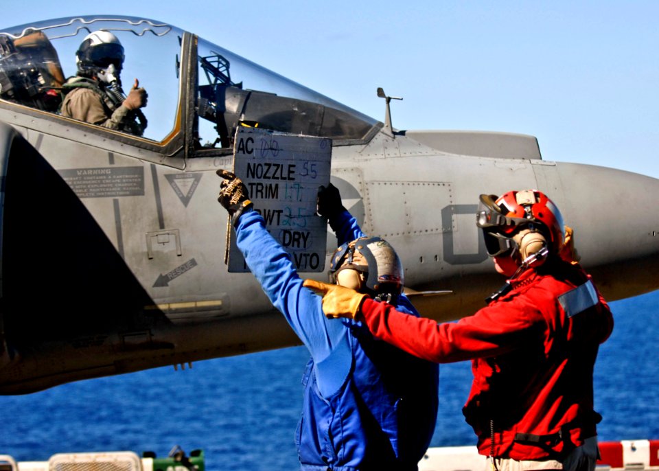 US Navy 090707-N-9950J-254 Aviation Boatswain's Mate (Handling) Airman Wagner Contreras, left, and Chief Aviation Boatswain's Mate (Handling) Geoffrey Wyatt prepare to launch an AV-8B Harrier aircraft
