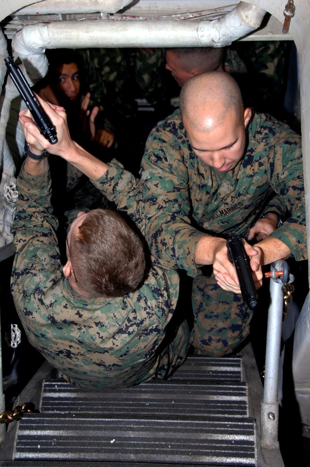 US Navy 090707-A-1839I-020 Lance Corporals Kyle Harris and Adam Reynolds from 2nd Marine Expeditionary Forces (MEF) demonstrate stairway clearing procedures while conducting training with Uruguayan Marines aboard amphibious doc