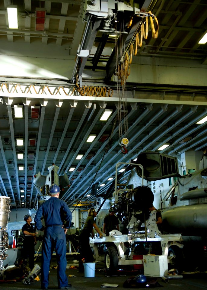 US Navy 090707-N-9520G-045 Sailors and Marines assigned to amphibious assault ship USS Essex (LHD 2) prepares to lift a T-64 Turbo shaft engine with a hanger bay crane
