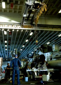 US Navy 090707-N-9520G-045 Sailors and Marines assigned to amphibious assault ship USS Essex (LHD 2) prepares to lift a T-64 Turbo shaft engine with a hanger bay crane
