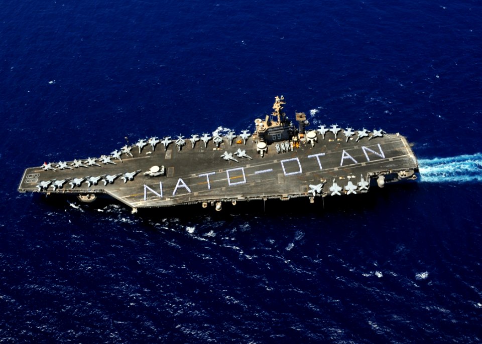 US Navy 090708-N-9988F-002 Sailors assigned to the Eisenhower Carrier Strike Group form on the flight deck of the aircraft carrier USS Dwight D. Eisenhower (CVN 69) to spell out
