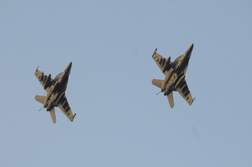 US Navy 090707-N-3610L-365 Two F-A-18 Super Hornets fly in synchronization around USS Ronald Reagan