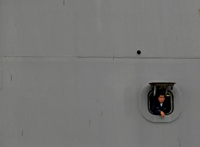 US Navy 090708-N-0807W-247 A Sailor assigned to the amphibious transport dock ship USS New Orleans (LPD 18) looks out from a mooring station during sea and anchor detail as the ship arrives in Sasebo for a scheduled port visit