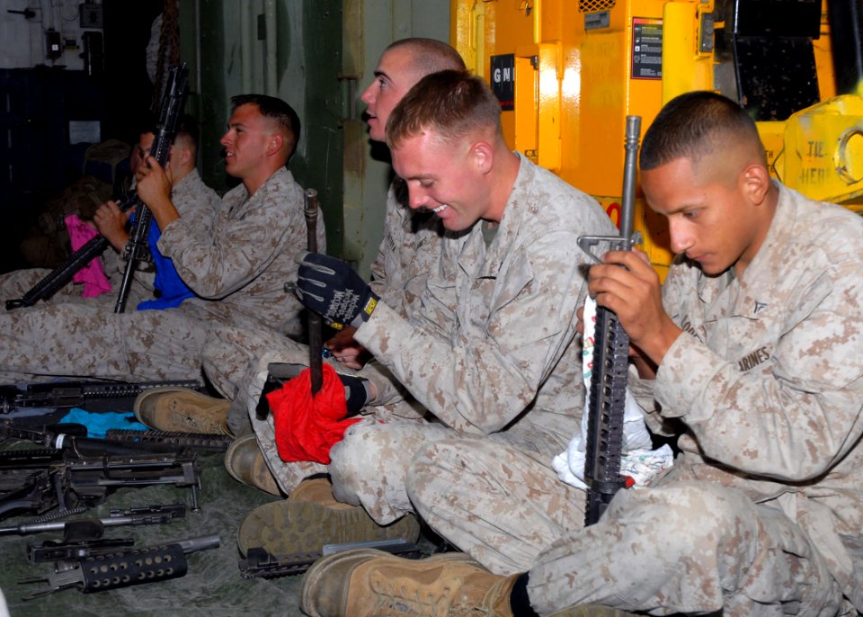 US Navy 090706-N-0515W-044 Marines assigned to Battalion Landing Team 24 clean and maintain M16 assault rifles and squad automatic weapons (SAW) aboard the amphibious assault ship USS Bonhomme Richard (LHD 6)