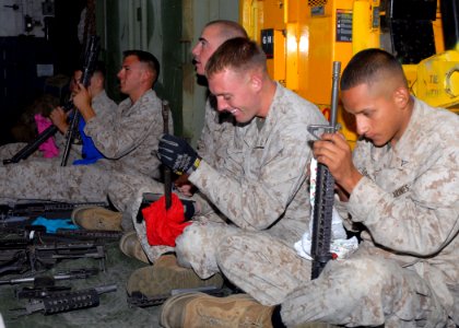 US Navy 090706-N-0515W-044 Marines assigned to Battalion Landing Team 24 clean and maintain M16 assault rifles and squad automatic weapons (SAW) aboard the amphibious assault ship USS Bonhomme Richard (LHD 6)