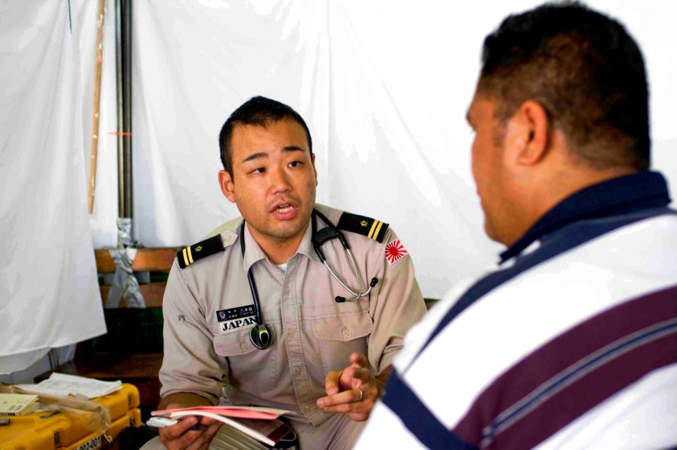 US Navy 090707-N-9689V-005 Japan Maritime Self Defense Force Lt. Kei Mikita consults locals suffering from joint pain or skin conditions at a Pacific Partnership 2009 Medical Civic Action Project
