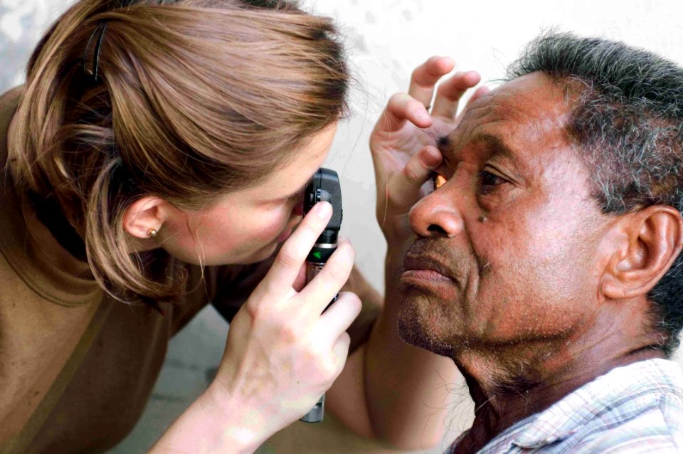 US Navy 090707-N-9689V-010 Lt. Jackie Anderson, optometrist, conducts an eye exam with a local man at a Pacific Partnership 2009 Medical Civic Action Project