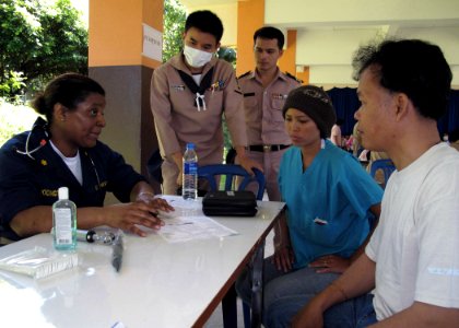 US Navy 090710-N-8539M-204 Lt. Cmdr. Rhonda Brockington asks a patient questions through a translator as part of a Medical Civil Action Project here. Brockington is a Naval Reserve physician attached to Operational Health Supp photo