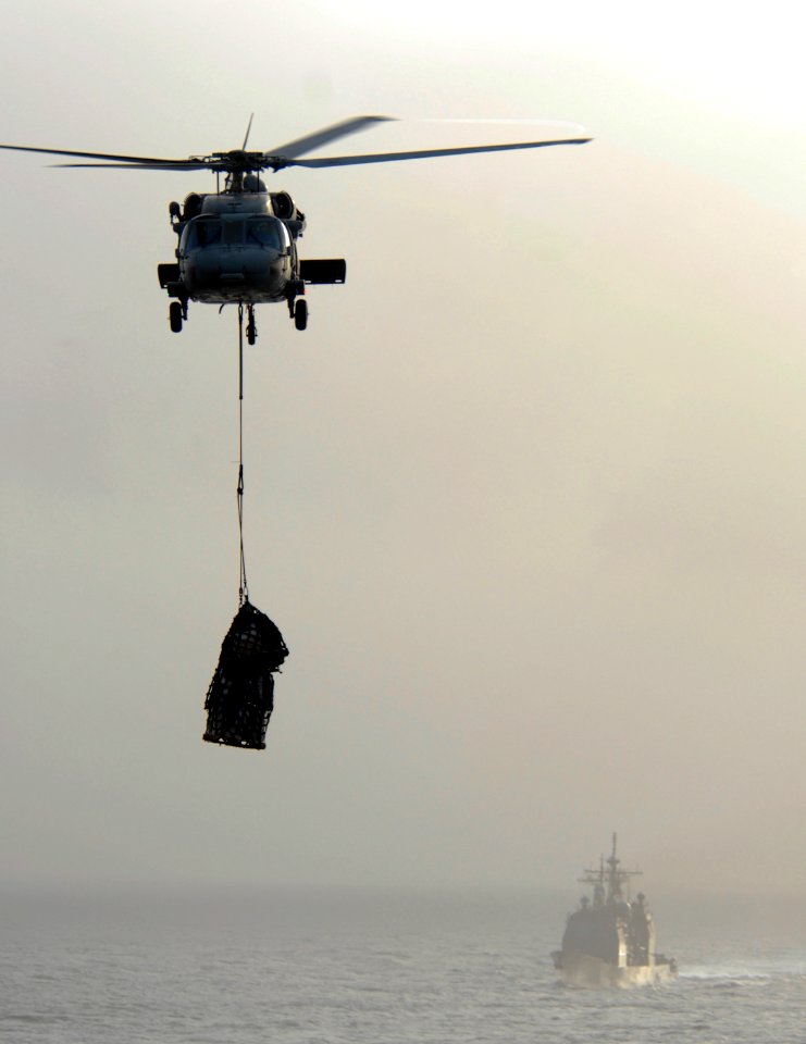 US Navy 090707-N-9132C-075 A MH-60S Sea Hawk assigned to the Black Jacks from Helicopter Sea Combat Squadron (HSC) 21 transports cargo from USNS Rainier
